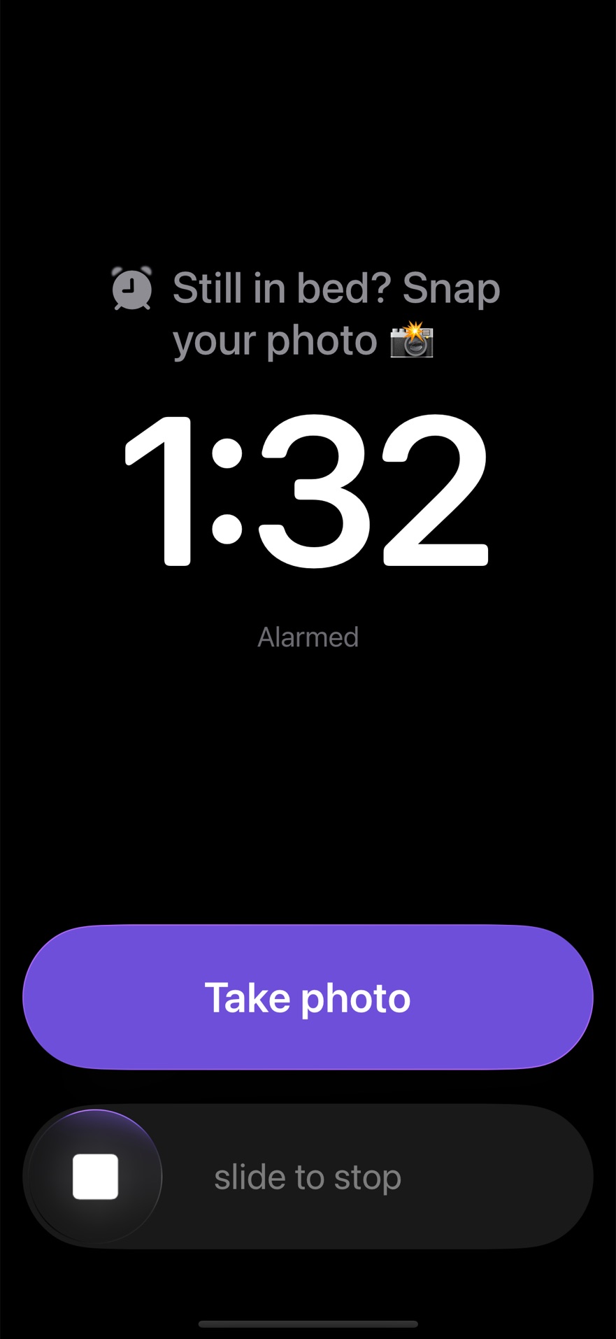 A full-screen alarm reading Still in bed? Snap your photo, with Take photo above slide to stop.